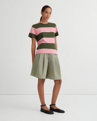 Woman wearing a striped shirt and skirt on a white background