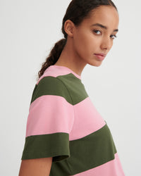 Woman wearing a pink and green striped shirt on a white background
