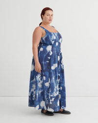 Woman wearing a blue floral dress on a white background