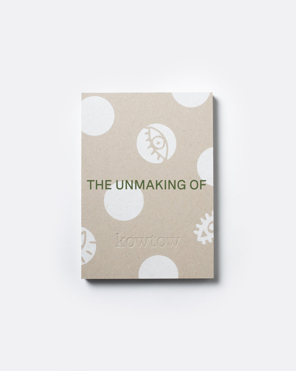 A square kraft paper notebook or book cover with white polka dots and minimalist illustrations, featuring the text 'THE UNMAKING OF' and the brand name 'kowtow' in green, shown on a light gray background.