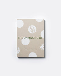 A square kraft paper notebook or book cover with white polka dots and minimalist illustrations, featuring the text 'THE UNMAKING OF' and the brand name 'kowtow' in green, shown on a light gray background.
