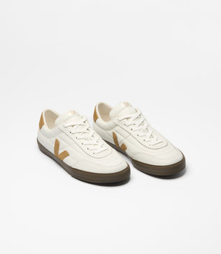 A pair of Veja low-top sneakers in off-white leather with tan accents and dark brown soles, shown on a clean white background.