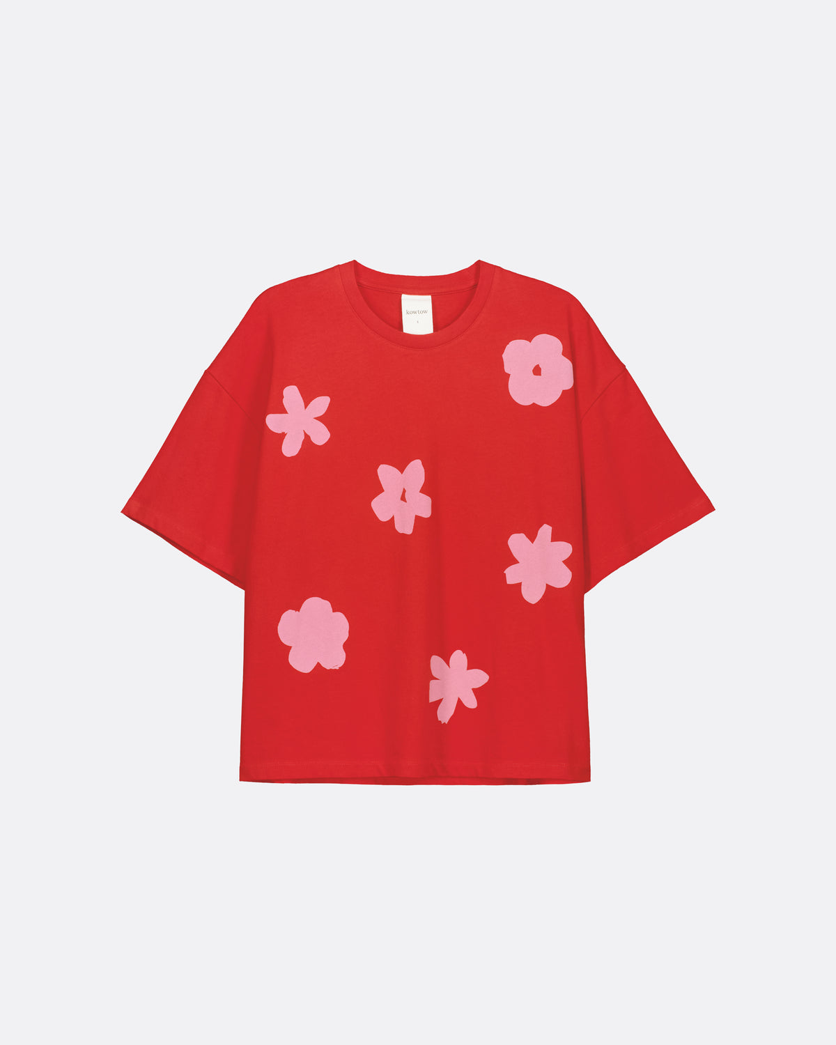 A red short-sleeve t-shirt with a pattern of light pink abstract flower shapes, displayed flat against a light gray background.