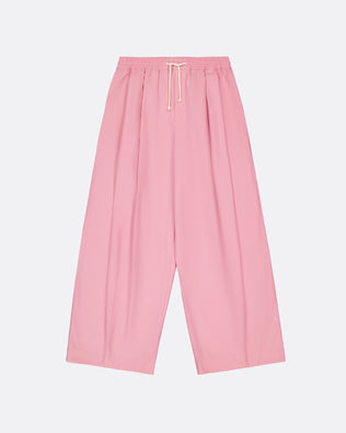 A pair of wide-leg, pleated pink pants with an elastic waistband and a white drawstring, shown flat against a light gray background.
