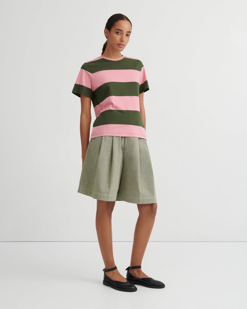 Woman wearing a striped shirt and skirt on a white background