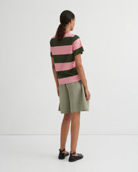 Person wearing a striped shirt and skirt on a white background