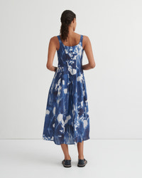 Woman wearing a blue floral dress on a white background