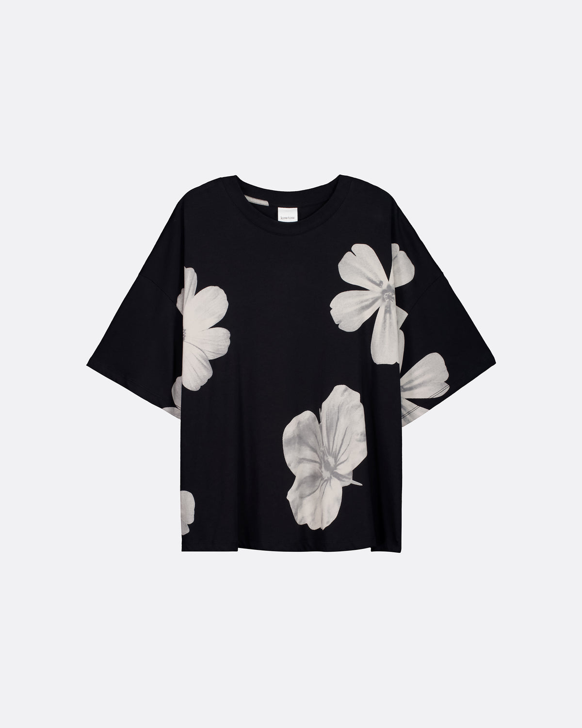 A black short-sleeve t-shirt with a large white floral print, displayed flat against a light gray background.