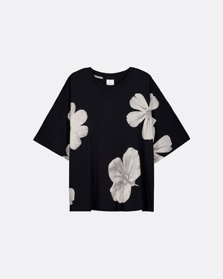 A black short-sleeve t-shirt with a large white floral print, displayed flat against a light gray background.