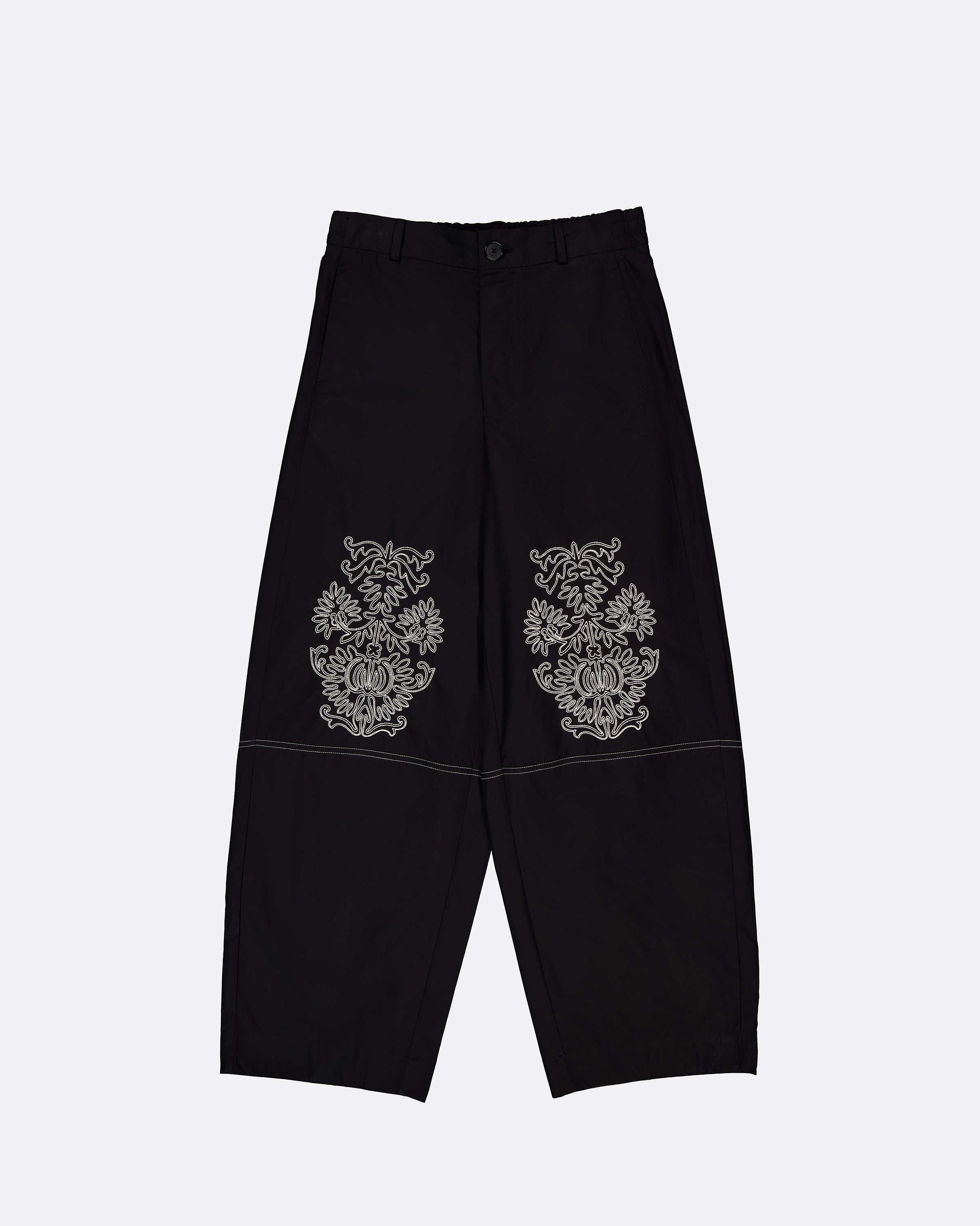 Black wide-leg cropped pants with ornate embroidered motifs on the upper thighs, displayed flat against a light gray background.