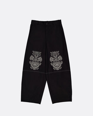 Black wide-leg cropped pants with ornate embroidered motifs on the upper thighs, displayed flat against a light gray background.