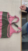 Tutorial video of a sleeveless knotted dress in pink and green stripes demonstrating how to tie knots.